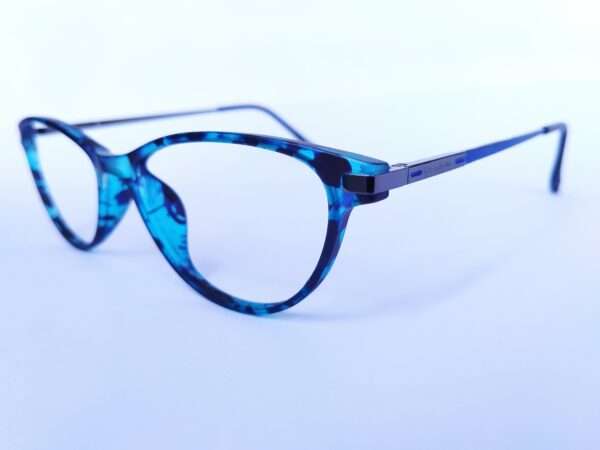 Blue black oval eyeglasses with a sleek metal-acetate frame, lightweight comfort, and modern appeal for men and women.