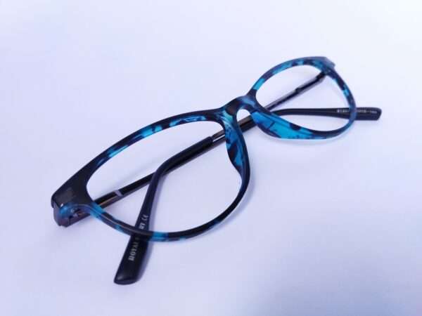 Blue black oval eyeglasses with a sleek metal-acetate frame, lightweight comfort, and modern appeal for men and women.