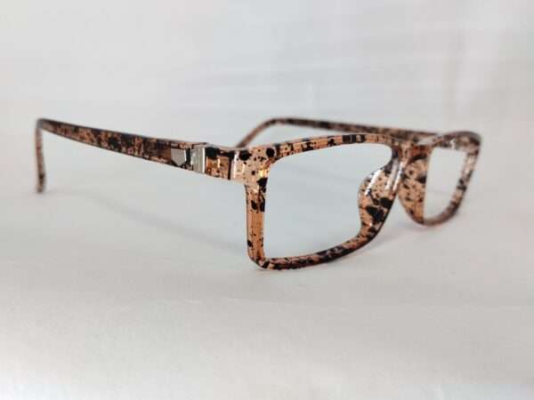 Glossy light brown and black eyeglass frame with a bold tiger-stripe pattern, featuring a modern and stylish design