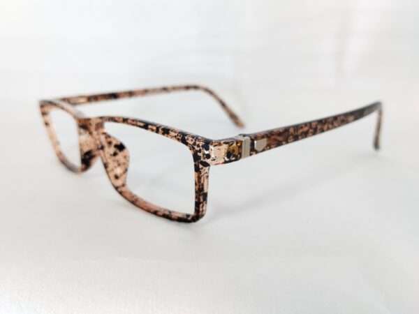 Glossy light brown and black eyeglass frame with a bold tiger-stripe pattern, featuring a modern and stylish design