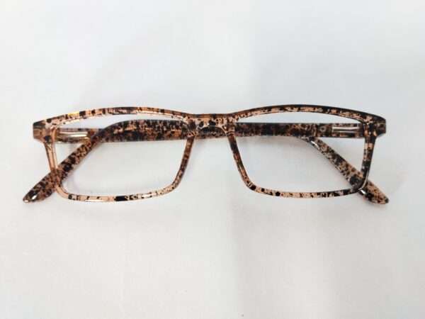 Glossy light brown and black eyeglass frame with a bold tiger-stripe pattern, featuring a modern and stylish design