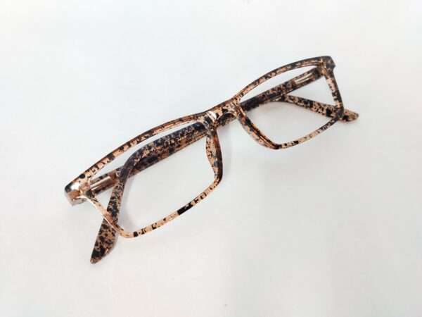 Glossy light brown and black eyeglass frame with a bold tiger-stripe pattern, featuring a modern and stylish design