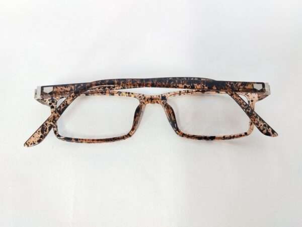 Glossy light brown and black eyeglass frame with a bold tiger-stripe pattern, featuring a modern and stylish design