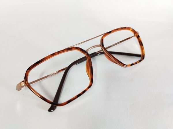 Stylish new eyeglass frames in brown, black, and silver featuring a bold tiger-themed design