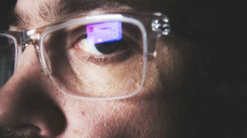 Person wearing industrial safety glasses for eye protection at work.