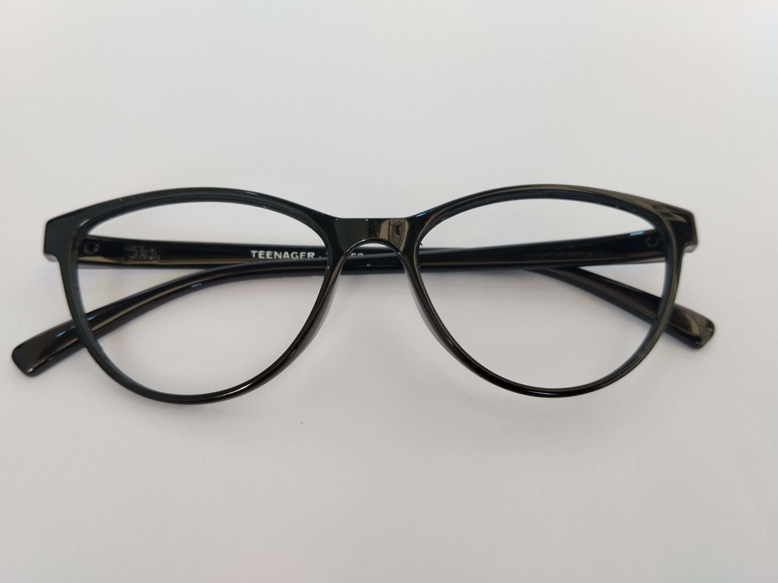 Black cat eye eyeglasses frames for women with sleek black acetate design and polished winged edges.