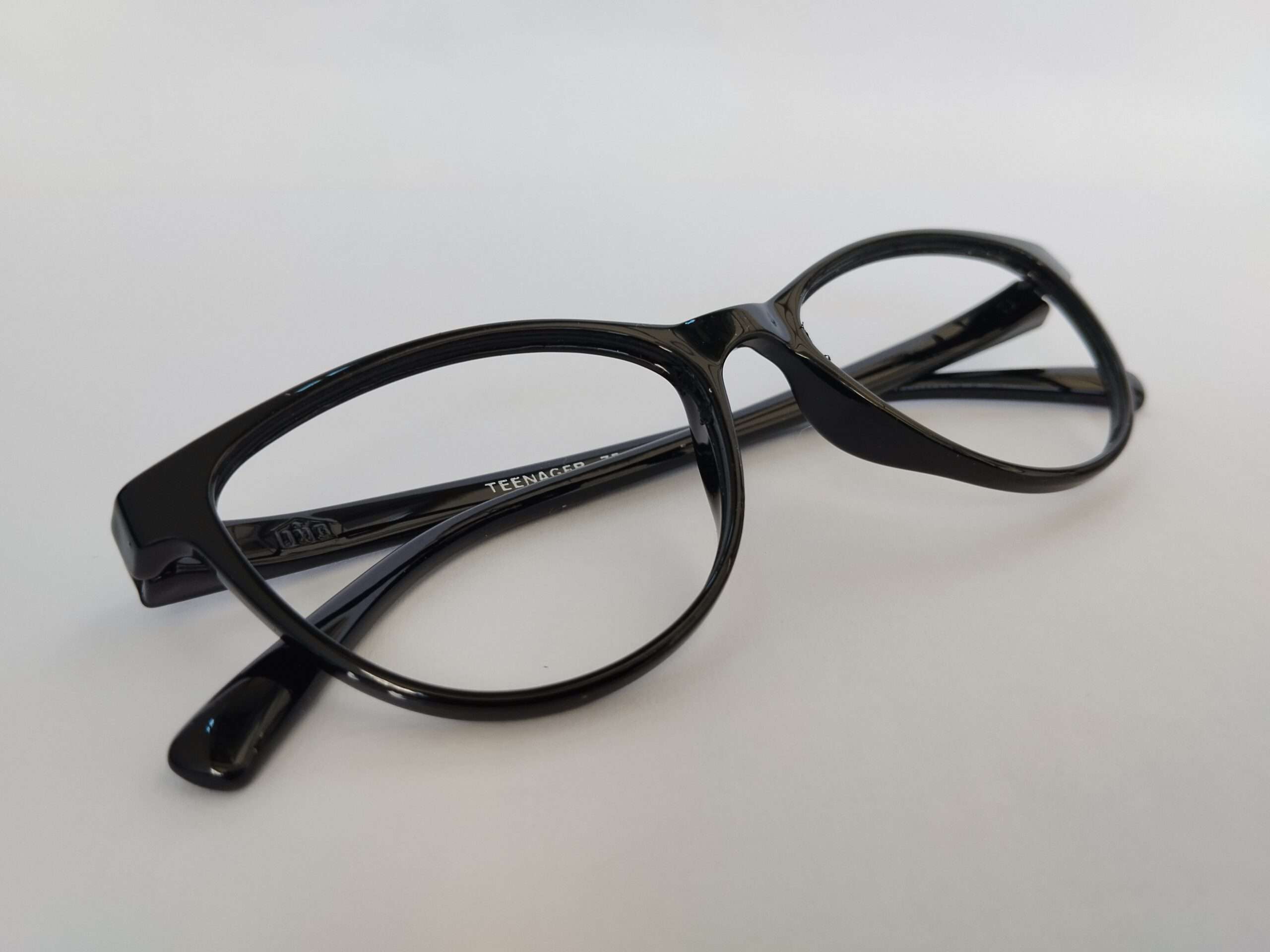 Black cat eye glasses with sharp upswept design and modern glossy finish