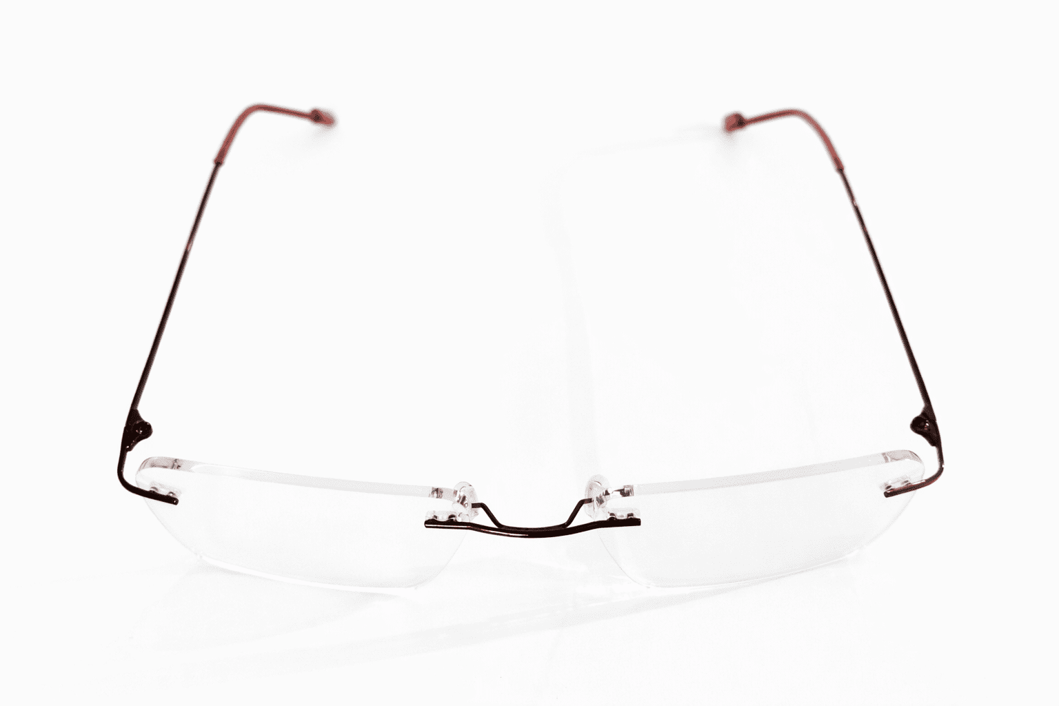 Maroon frameless rectangle reading glasses for women with lightweight elegant design and clear lenses